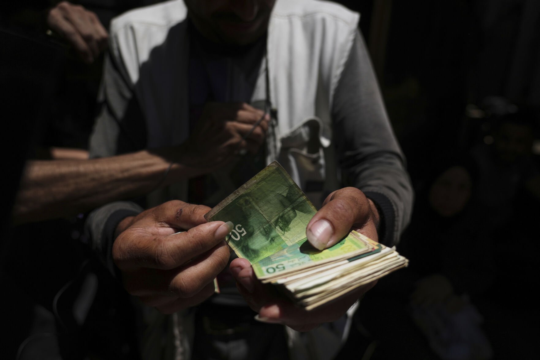  Cash is scarce in Gaza. Palestinians are paying a high price to get it