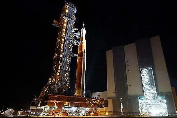 NASA hauls repaired moon rocket from hangar back to pad for early April launch