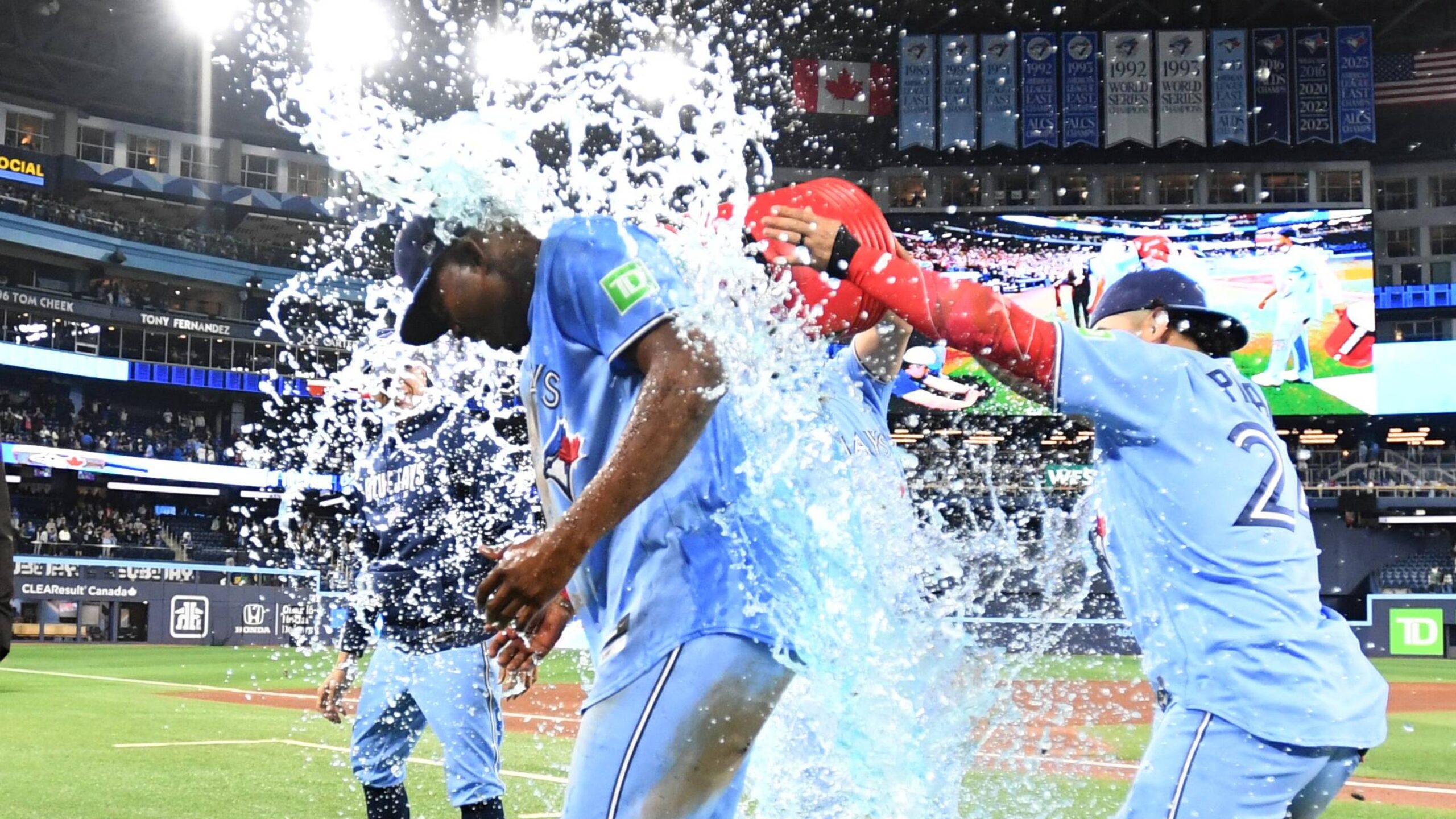 Toronto Blue Jays right fielder Jesus Sanchez (12) is doused with ice water by teammates as they celebrate a win.