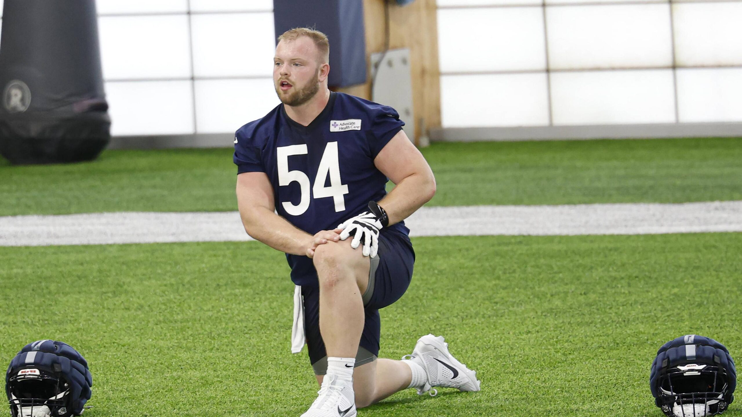 Logan Jones goes through stretching at Bears rookie camp. The former Iowa center is now working with the second team.