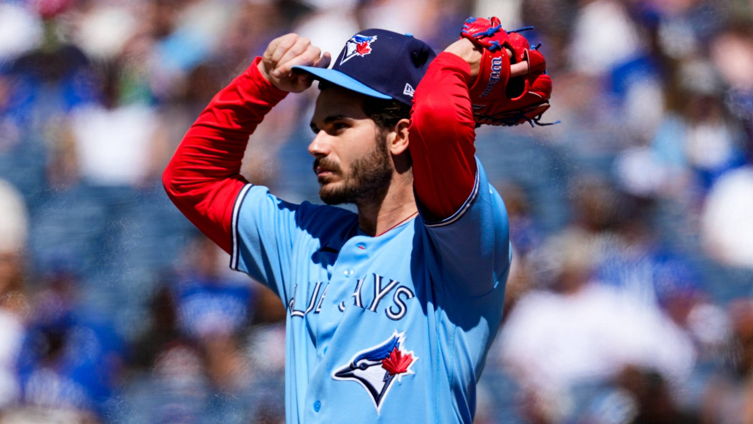 Toronto Blue Jays pitcher Dylan Cease (84) adjusts his hat.