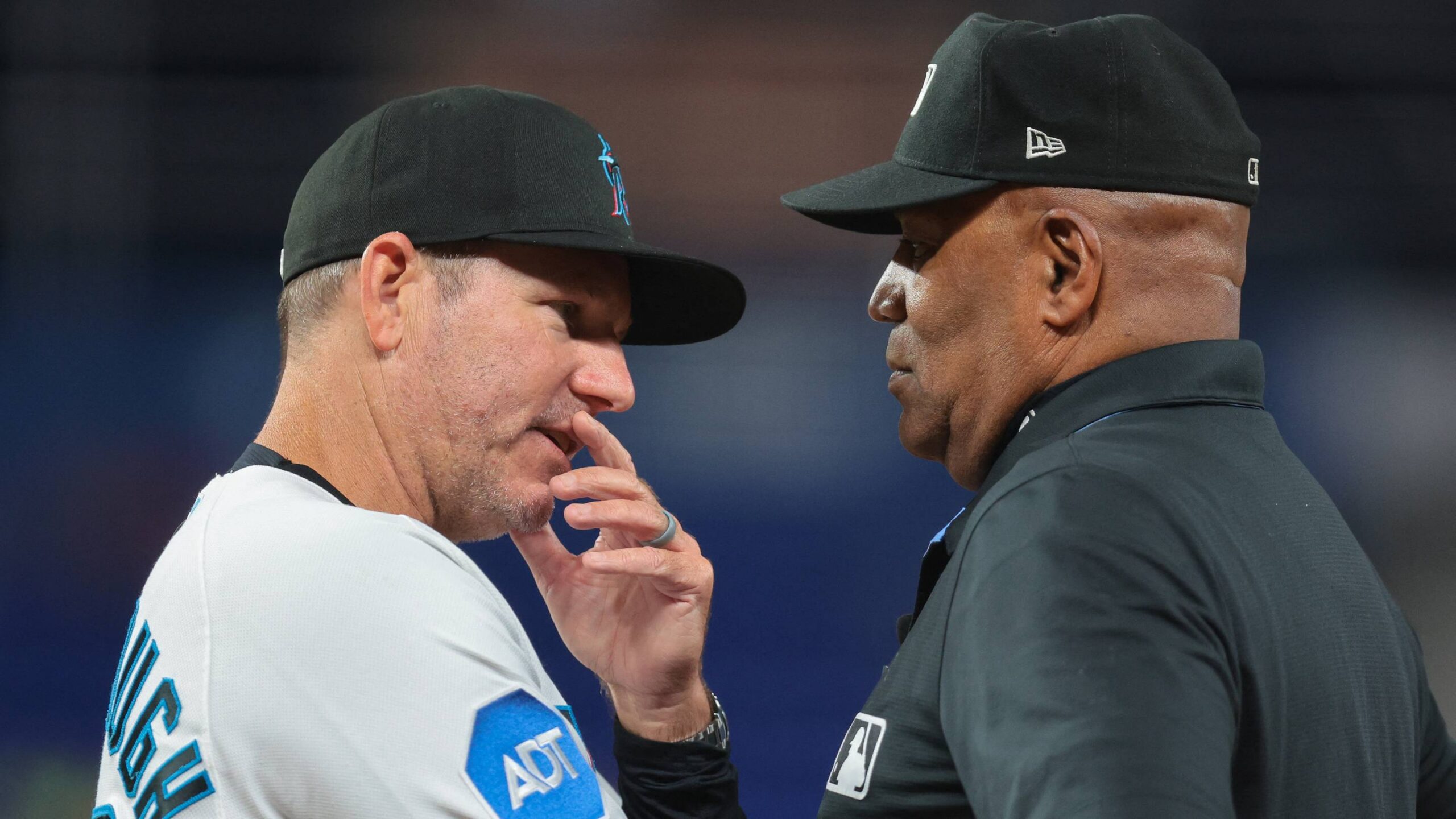 Miami Marlins manager Clayton McCullough and umpire Laz Diaz.