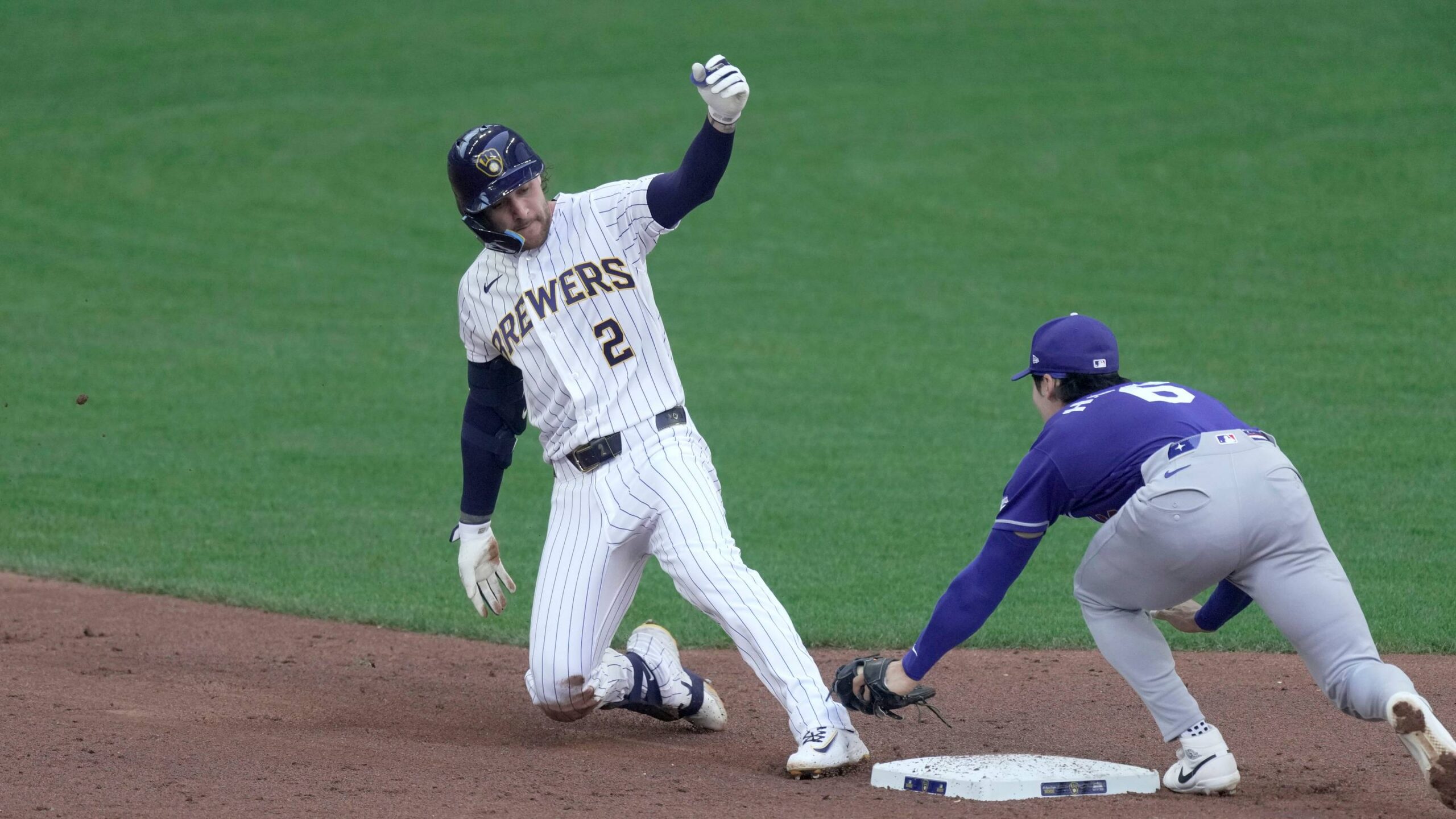 Milwaukee Brewers second baseman Brice Turang (2) is tagged out second base by Los Angeles Dodgers shortstop Hyeseong Kim (6) while trying to extend a single during the third inning of their game Sunday, May 24, 2026 at American Family Field in Milwaukee, Wisconsin.